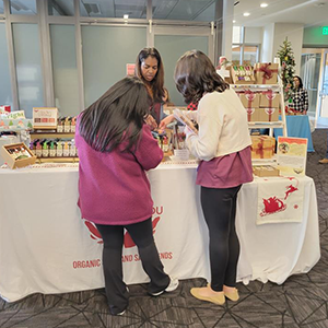 Woman helping mom and daughter shop