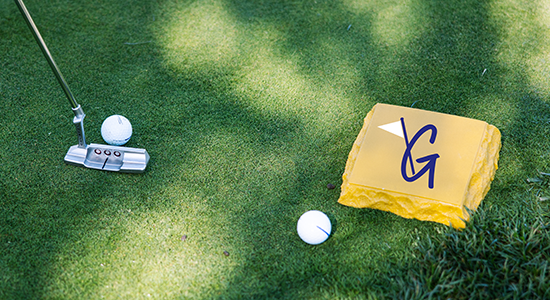 Golf club hitting ball